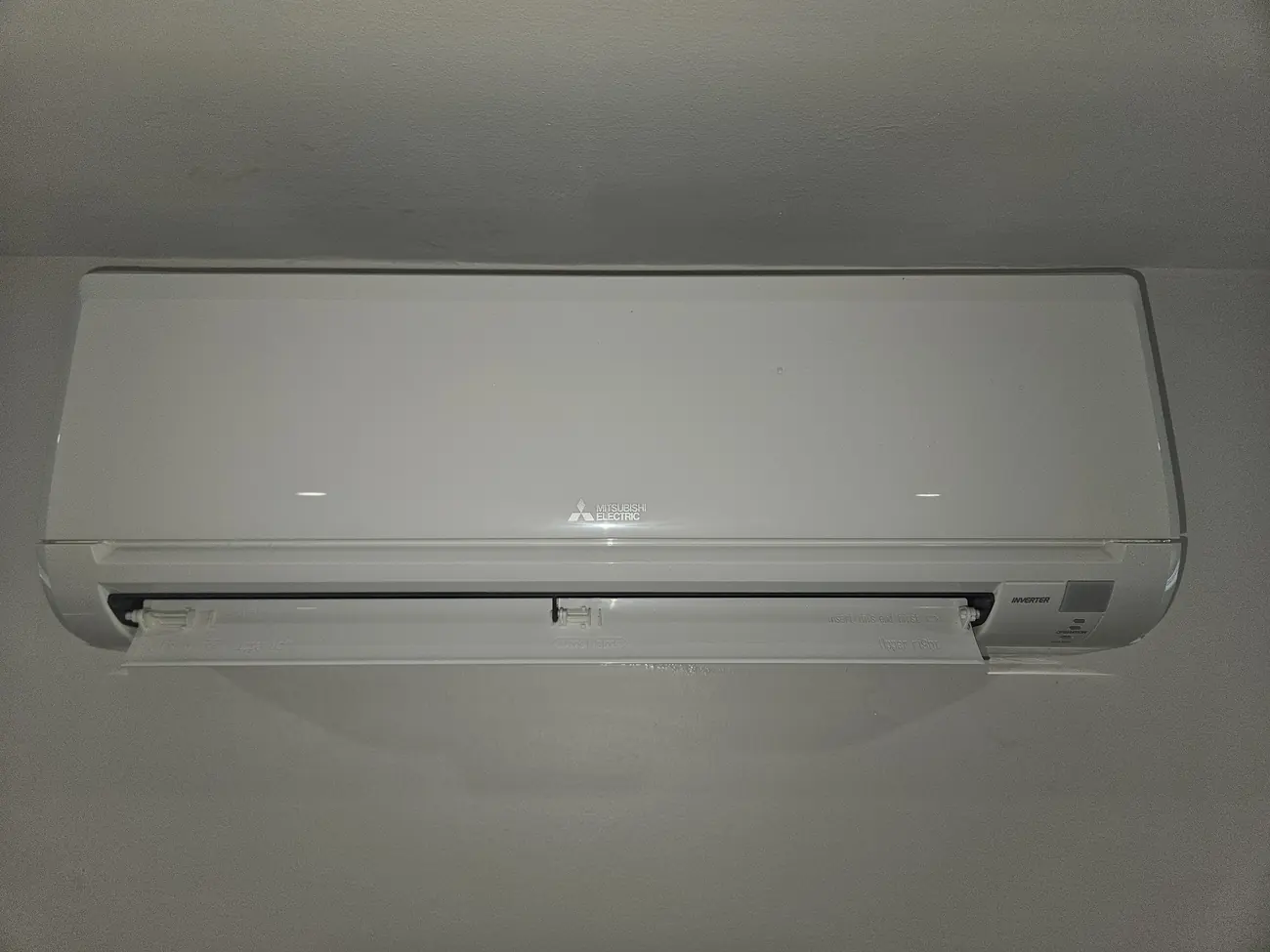 Mitsubishi mini-split back together and clean on the wall of a Brighton, MA apartment