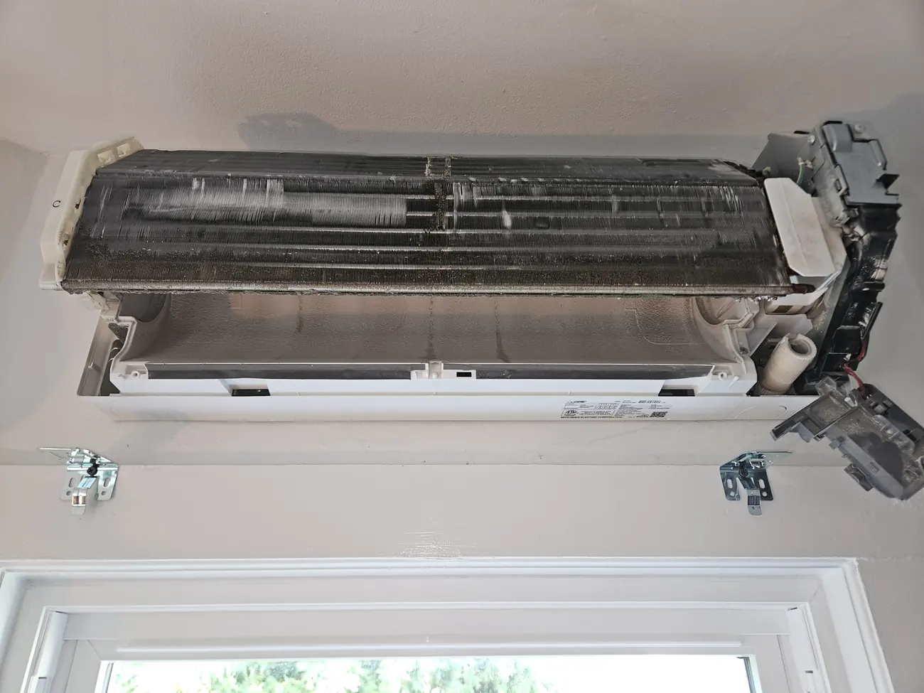 Mitsubishi indoor head opened on the wall of a Brighton MA apartment before cleaning