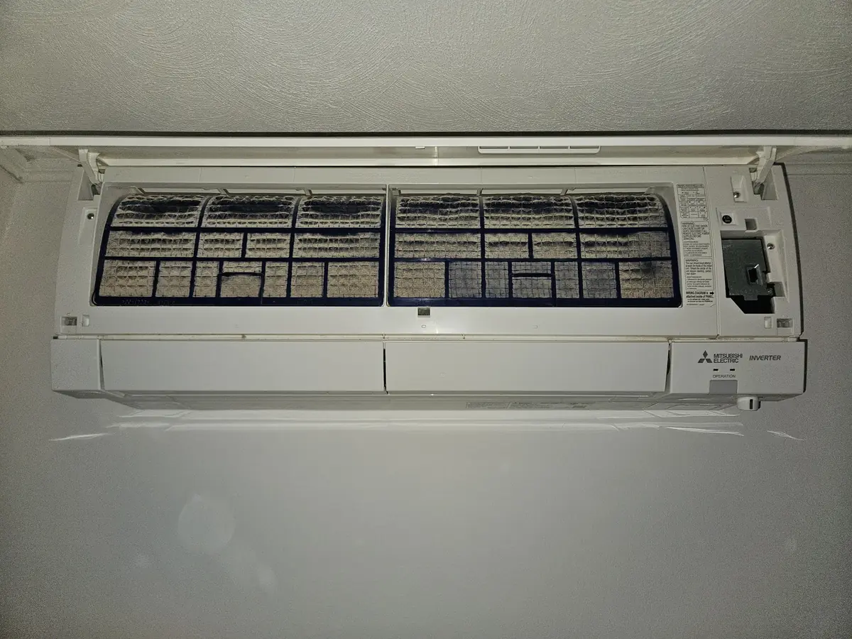 Mitsubishi mini-split in Concord, MA with filters loaded with dust before cleaning