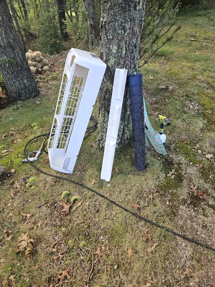 Mini-split cover, filter grille and blower wheel taken outside for washing at a Falmouth, MA job