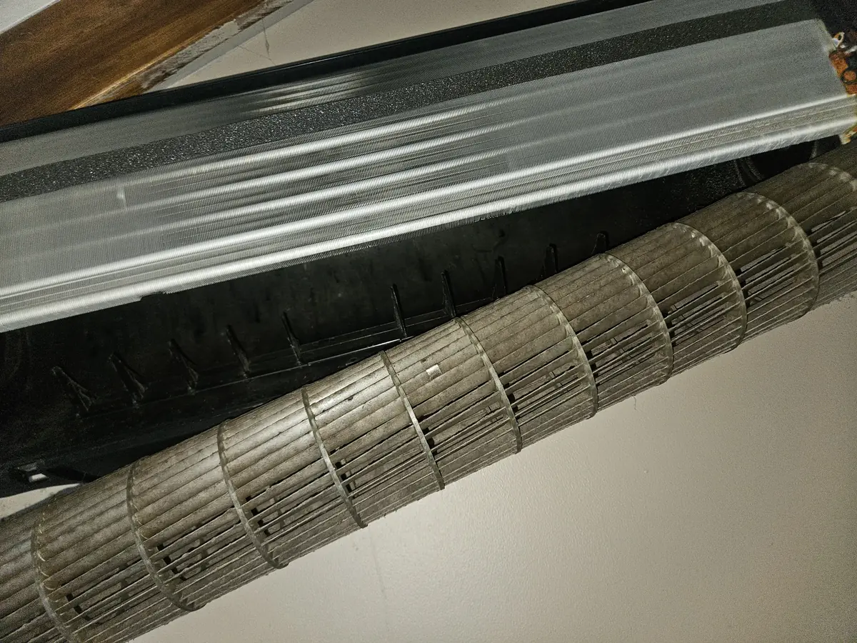 Grey blower wheel removed from an LG mini-split in Franklin MA, every vane coated
