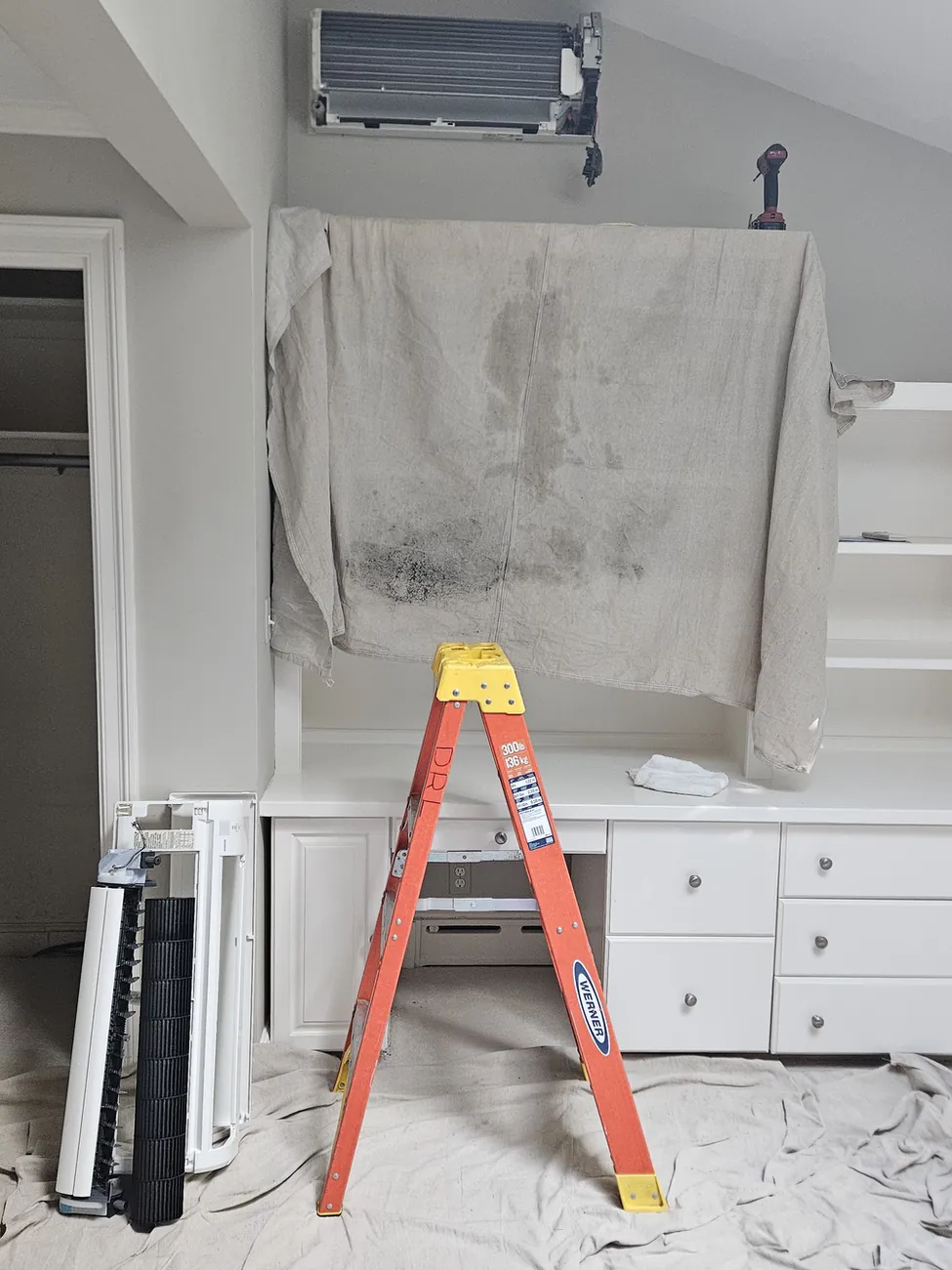Drop cloth below a mini-split in Lexington MA showing black mold washed out of the unit
