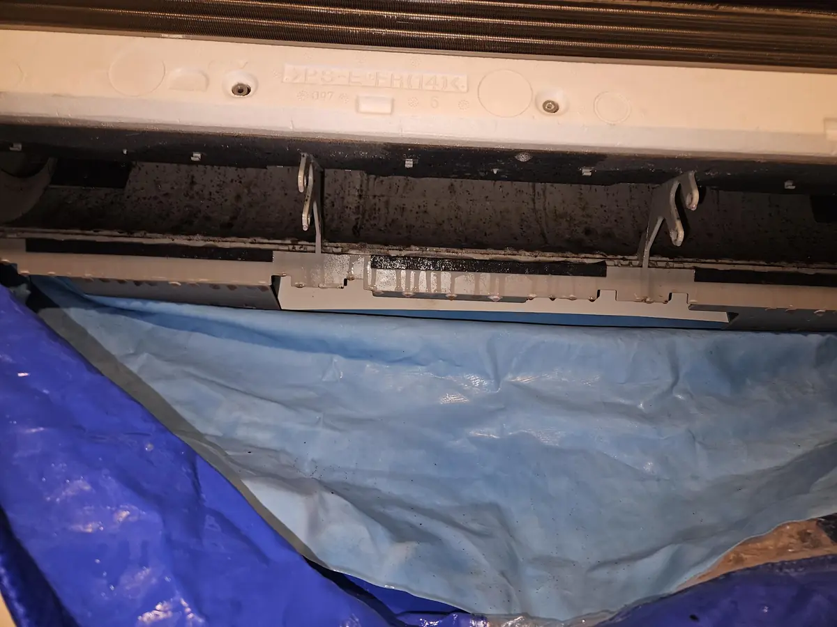 Mini-split bibbed with a tarp below before washing in a Londonderry, NH home