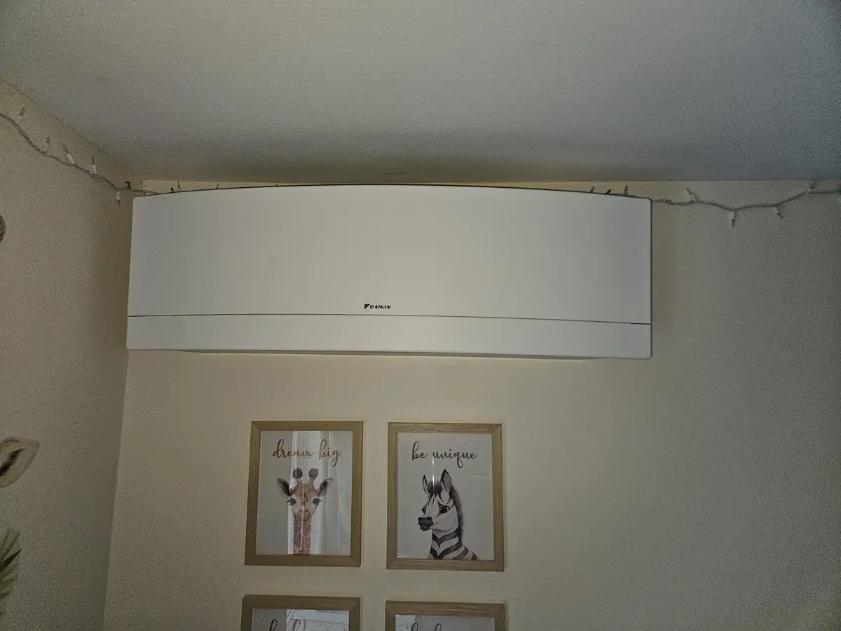 Daikin mini-split clean and back together on the wall of a bedroom in Pepperell, MA